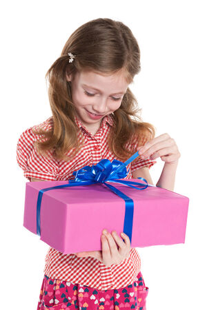 A pretty little girl holds a gift box on the white backgroundの写真素材