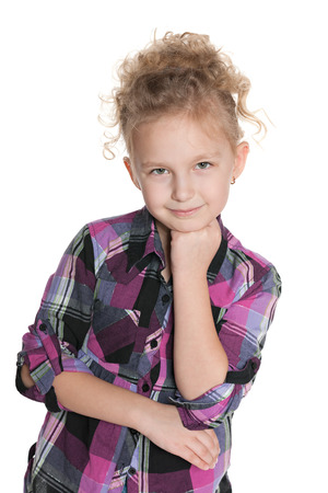 A thoughtful fashion little girl on the white backgroundの写真素材