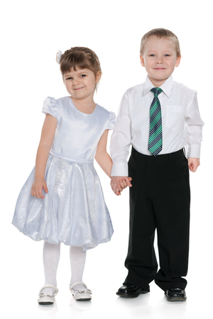 Two happy little kids are standing together on the white backgroundの写真素材