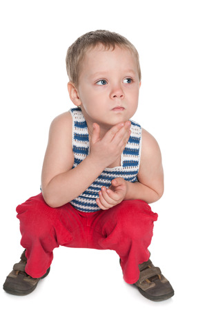 A very thoughtful preschool boy on the white backgroundの写真素材