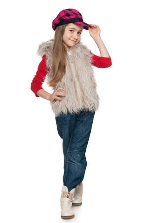A portrait of a smiling fashion little girl on the white backgroundの写真素材