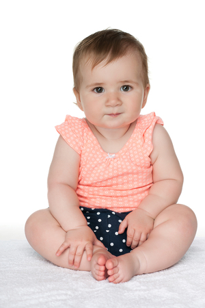 A cute baby girl on the white backgroundの写真素材