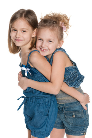 Two fashion little girls on the white backgroundの写真素材
