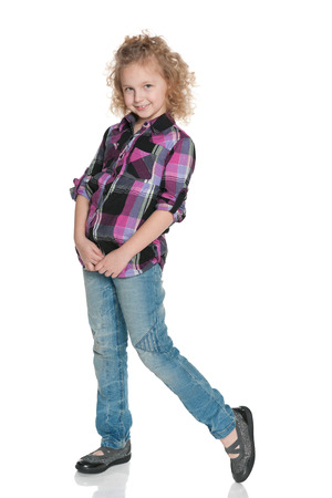 A portrait of a smiling fashion little girl on the white backgroundの写真素材