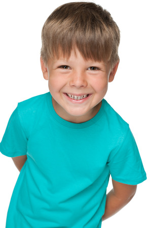 A portrait of a little happy boy in a blue shirt on the white backgroundの写真素材