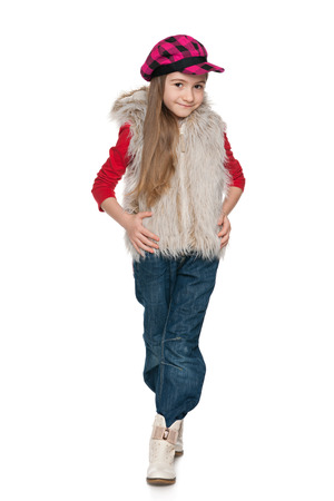 A portrait of a fashion smiling little girl on the white backgroundの写真素材