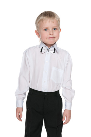 A portrait of a little schoolboy against the white backgroundの写真素材
