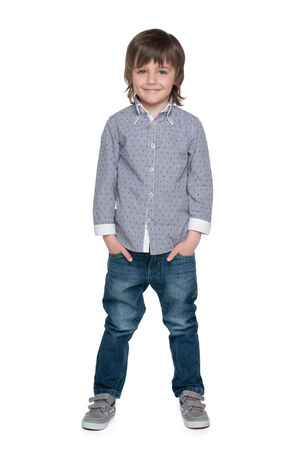 A portrait of a smiling fashion little boy against the white backgroundの写真素材