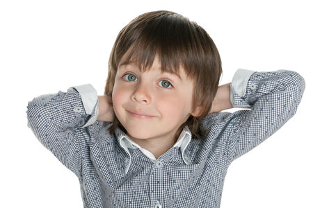A closeup portrait of a cute little boy against the white backgroundの写真素材