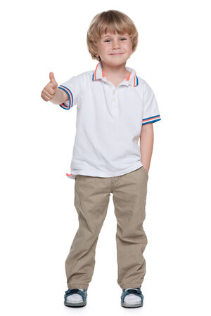 A small boy holds his thumb up on the white backgroundの写真素材