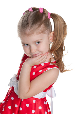 A portrait of a cute little girl in the polka dot on the white backgroundの写真素材