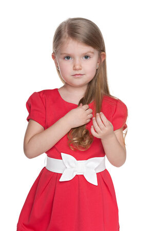 A portrait of a serious preschool girl against the white backgroundの写真素材