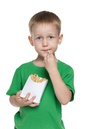 A cute little boy with fries on the white backgroundの写真素材