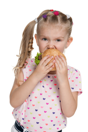 A pretty little girl with hamburger on the white backgroundの写真素材