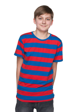 A portrait of a smiling teenager boy on the white backgroundの写真素材