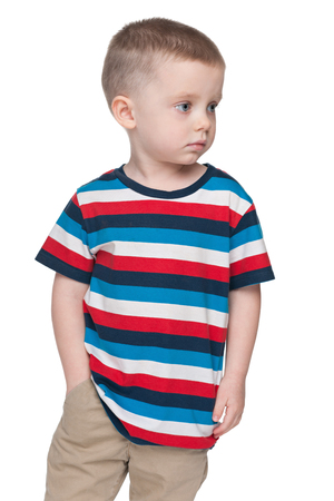 A thoughtful small boy looks aside on the white backgroundの写真素材