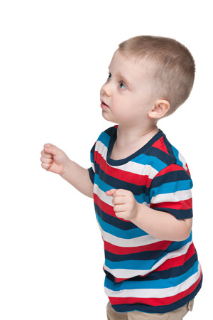 A little boy in anticipation on the white backgroundの写真素材