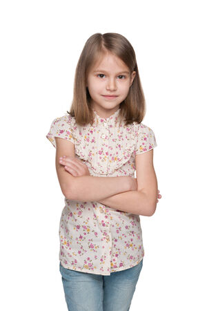 A portrait of a serious little girl against the white backgroundの写真素材