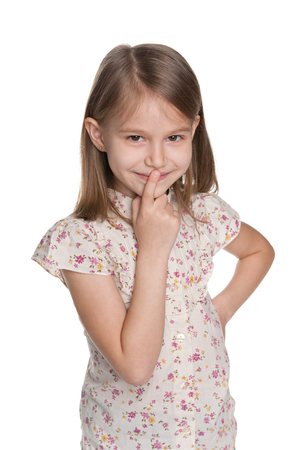 A closeup portrait of a curious young girl on the white backgroundの写真素材