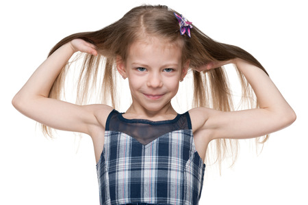 A portrait of an adorable little girl with flowing hair on the white backgroundの写真素材