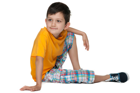 A portrait of a cute thoughtful young boy on the white backgroundの写真素材