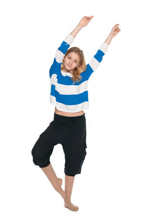 A pretty young girl does fitness exercises on the white backgroundの写真素材