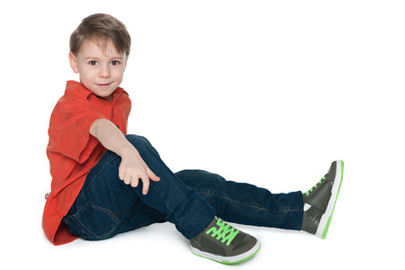 Cute preschool boy is resting on the white backgroundの写真素材