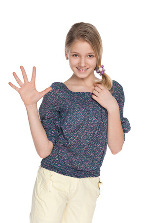 An adorable young girl makes a welcome gestureの写真素材