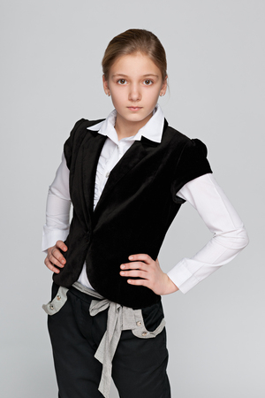 A portrait of a pensive preteen girl on the gray backgroundの写真素材