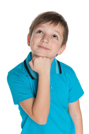 A portrait of a thoughtful smiling little boy on the white backgroundの写真素材