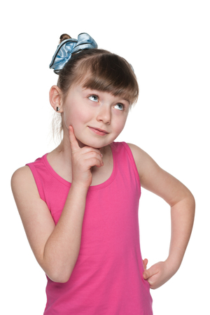 A lovely little girl looks up on the white backgroundの写真素材