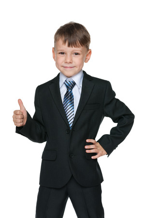 A school boy holds his thumb up on the white backgroundの写真素材