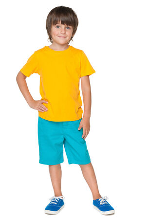 A young smiling boy in a yellow shirt on the white backgroundの写真素材