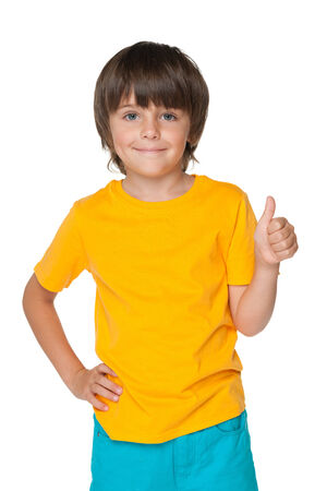 A handsome little boy holds his thumb up on the white backgroundの写真素材