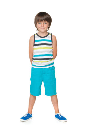 A young smiling boy in a striped shirt on the white backgroundの写真素材