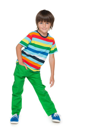 A portrait of a young smiling boy in a striped shirt on the white backgroundの写真素材