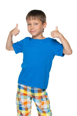 A cute little boy holds his thumbs up against the white backgroundの写真素材