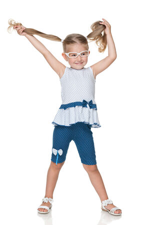 A pretty little girl with pigtails on the white backgroundの写真素材