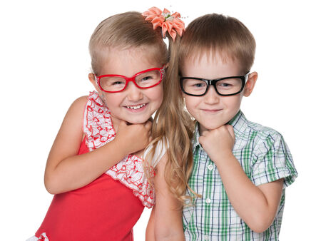 Two clever little kids stand on the white backgroundの写真素材