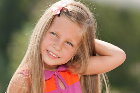 An outdoor portrait of a cheerful little girlの写真素材