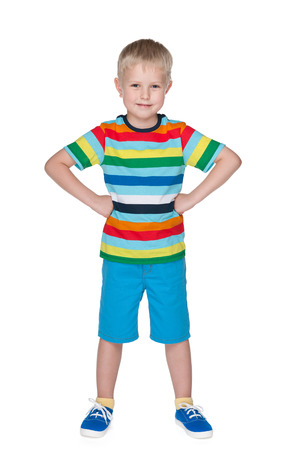 A portrait of a smiling little boy in a striped shirt on the white backgroundの写真素材