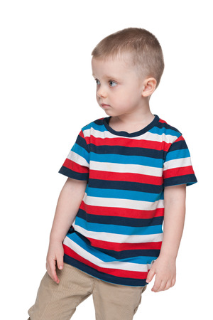 A pensive small boy looks aside on the white backgroundの写真素材
