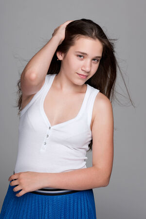 A portrait of a pretty teen girl against the gray backgroundの写真素材