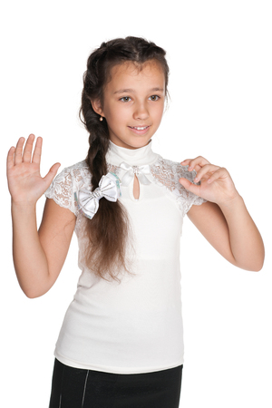 A smiling girl stretching his right hand up on the white backgroundの写真素材