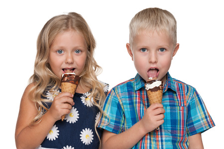 A portrait of two children with ice cream on the white backgroundの写真素材