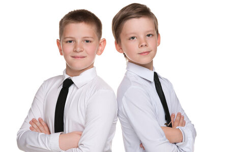 Two fashion handsome young boys are standing together on the white backgroundの写真素材