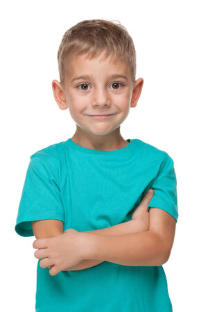 A portrait of a smiling little boy in a blue shirt on the white backgroundの写真素材