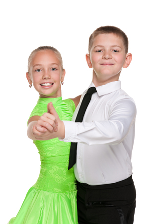 Boy and girl are dancing against the white backgroundの写真素材