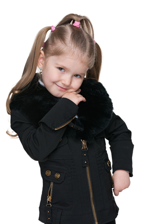 A portrait of a smiling  little girl in a black jacket on the white の写真素材