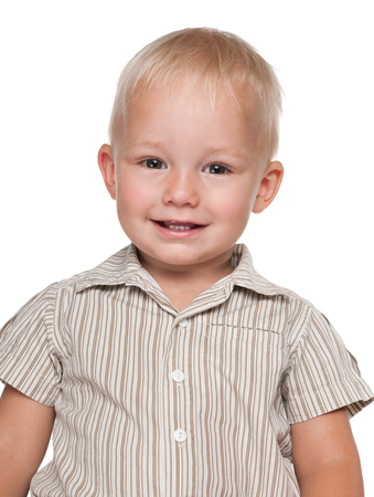 A portrait of a cheerful baby boy on the white の写真素材